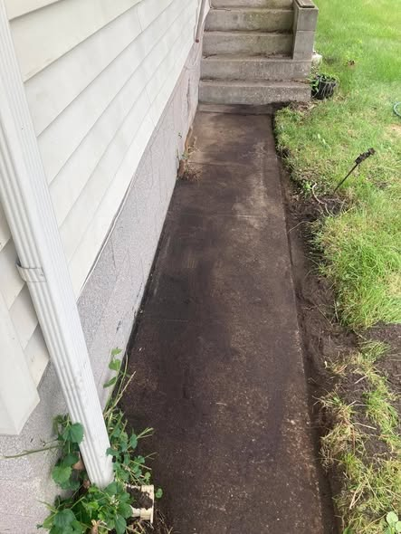 Weeds removed alongside the house — after