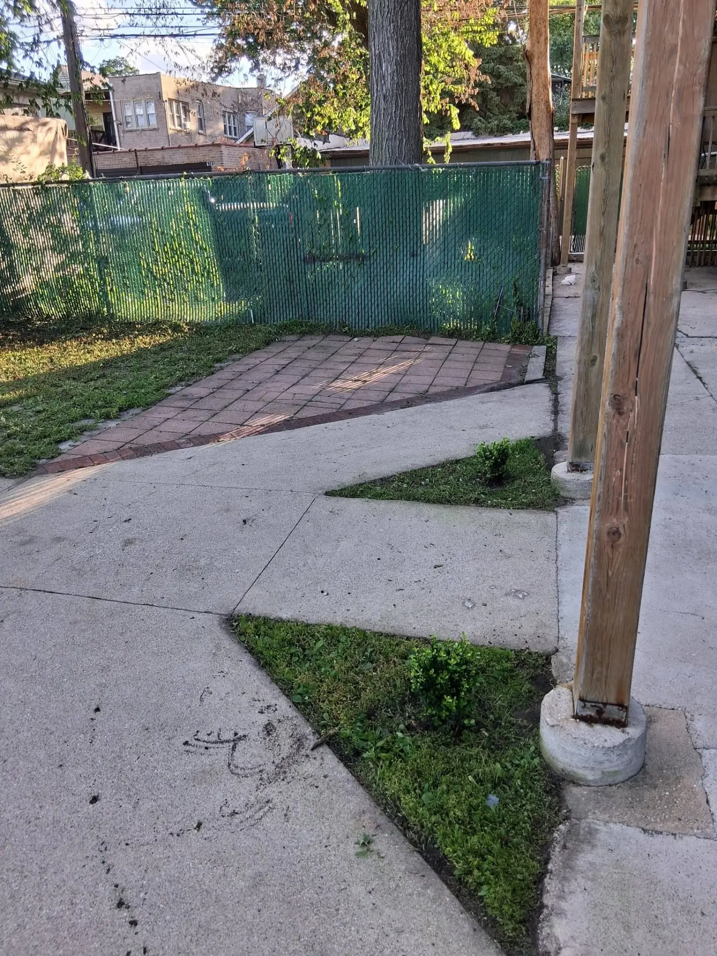 Overgrown walkway and patio area cleaned up — after